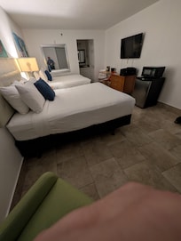 2 comphy queen beds with 4 pillows on each bed