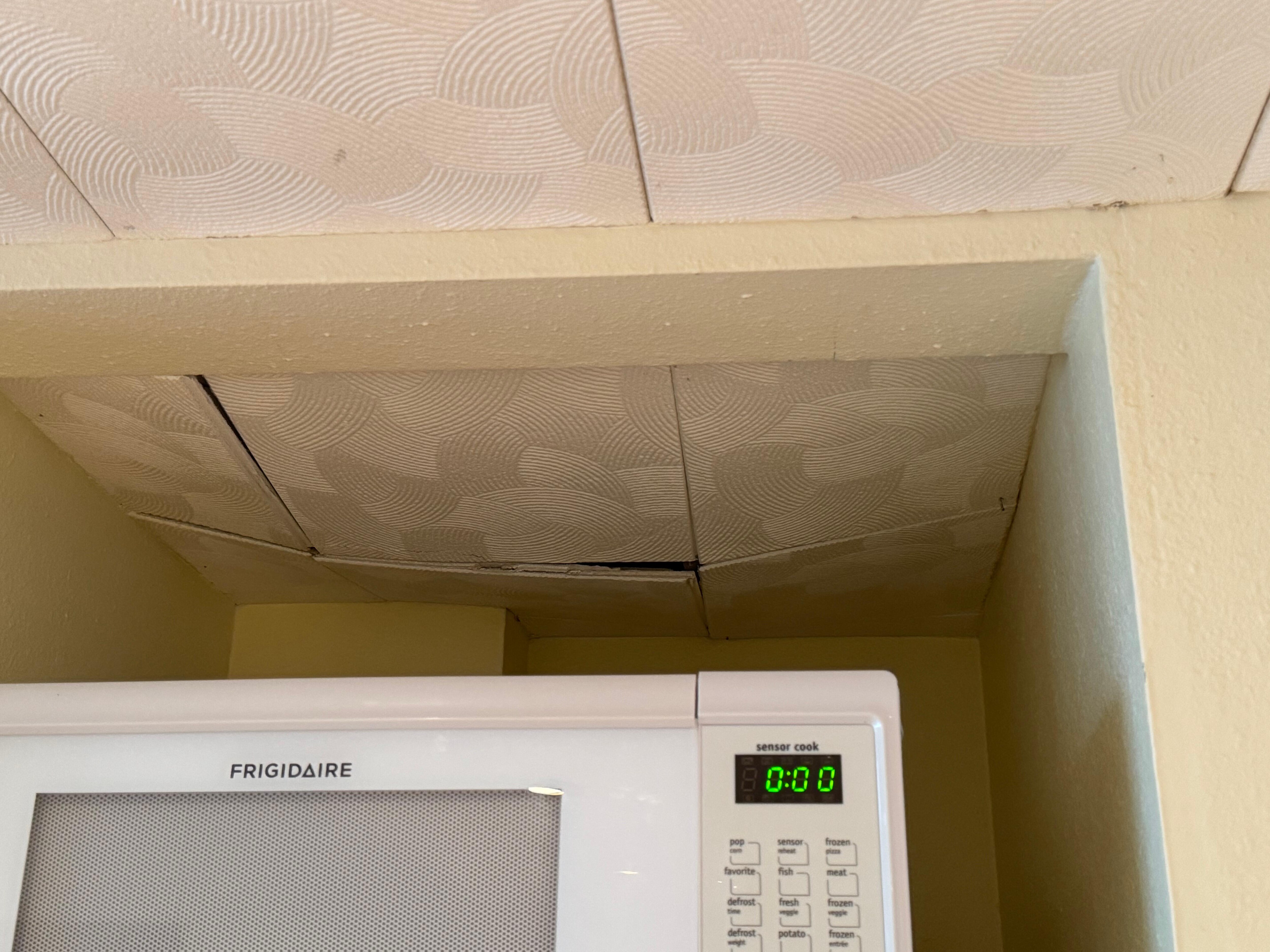 Ceiling caving it over the microwave