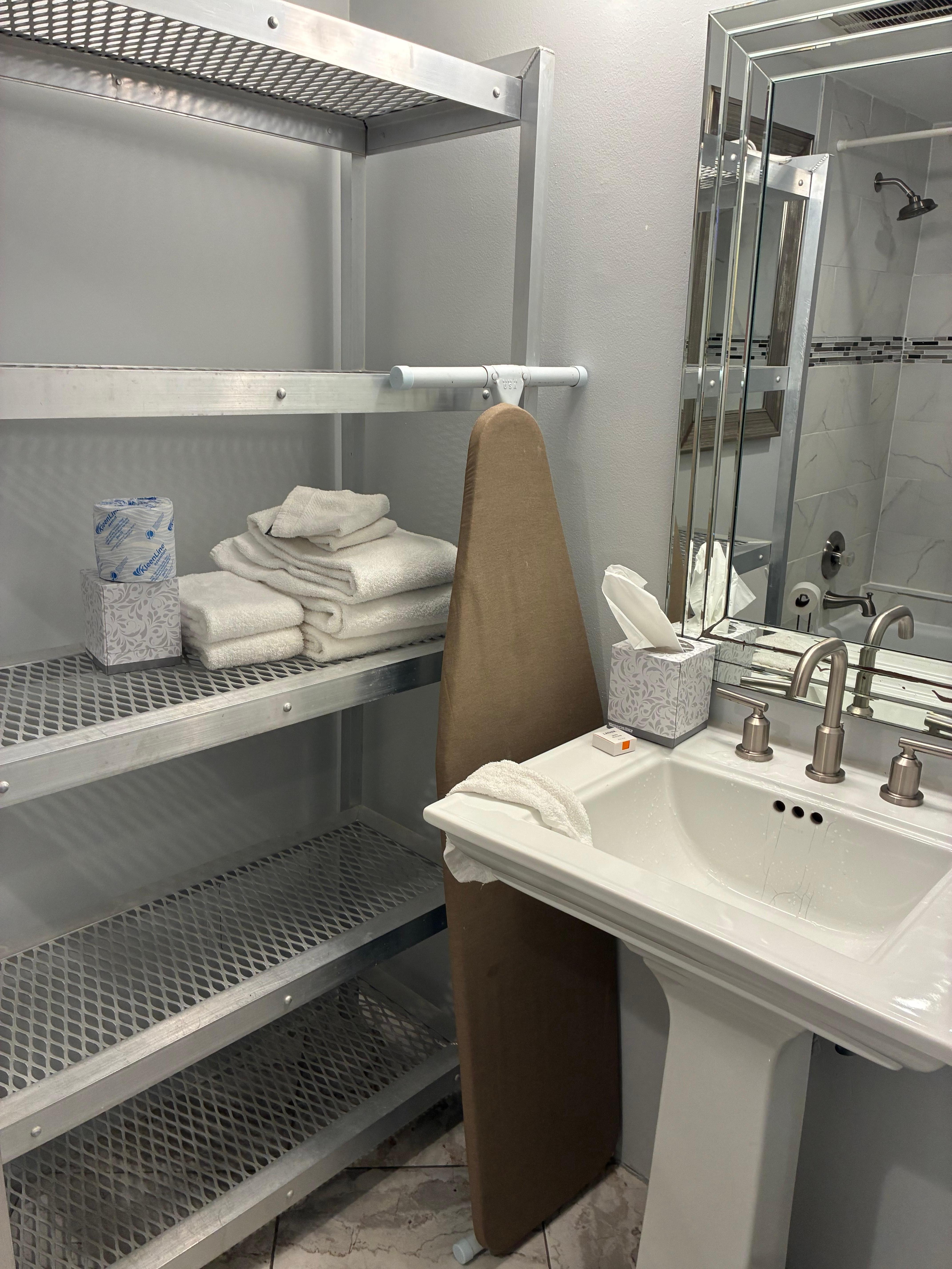 Metal shelf looked  cheap and out of place. Ironing board doesn’t seem put away. 