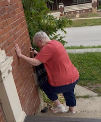 My 76-year-old mother trying to get down the front steps no handrail