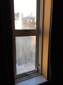 Filthy window that overlooked the noisy alleyway