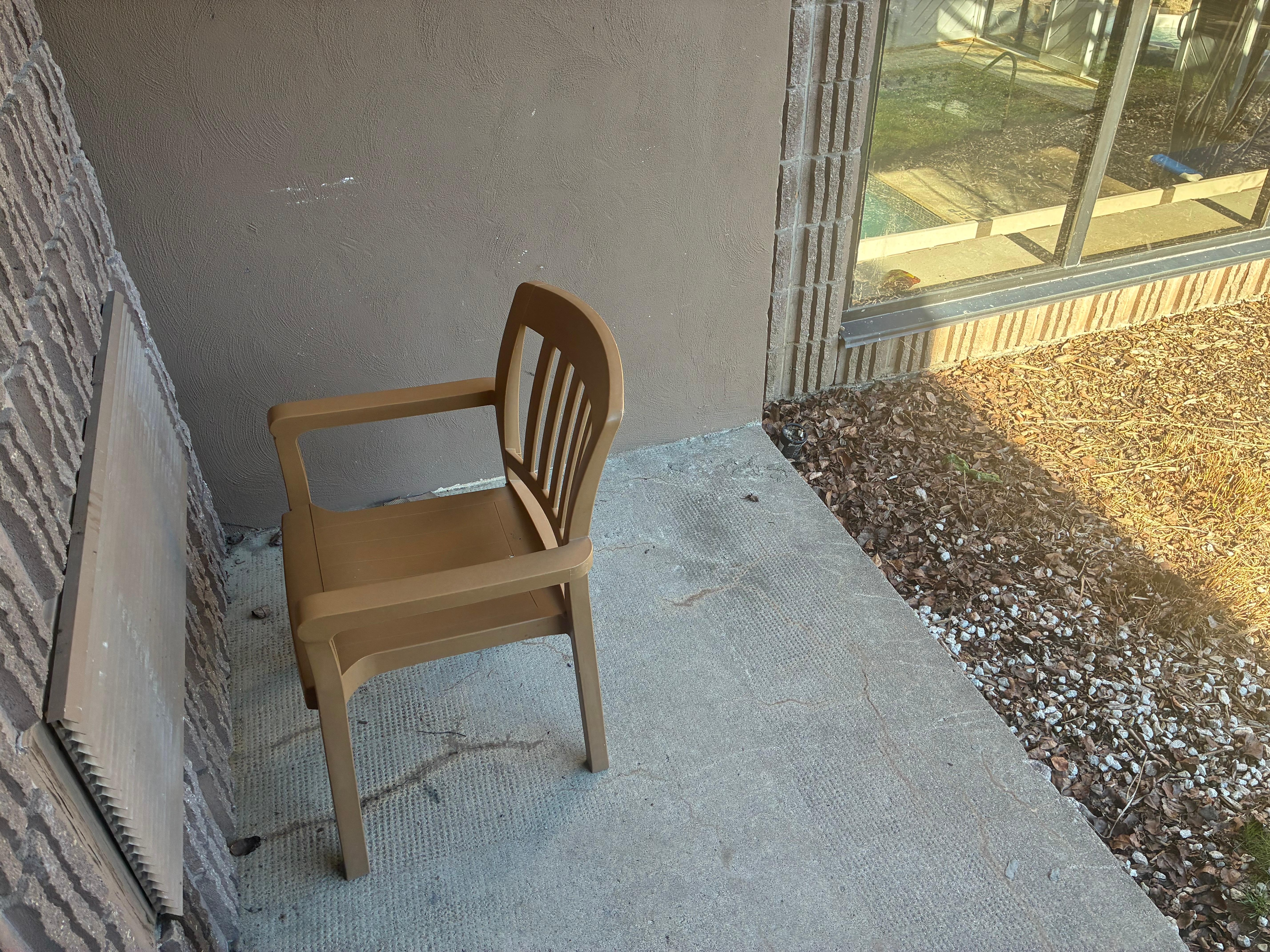 Dirty patio. Cigarette can a poo bag edge of leaf area-top left