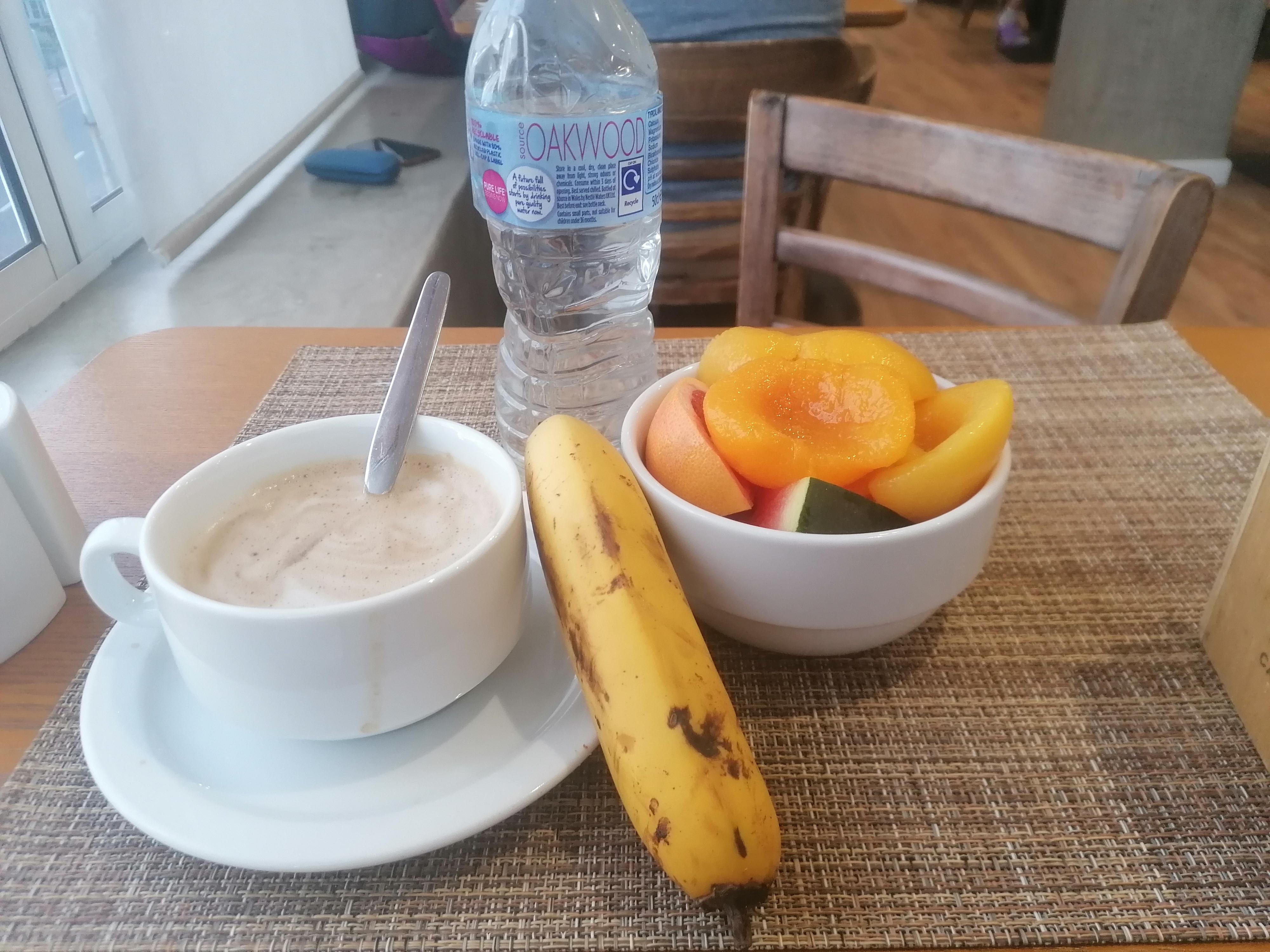 Health breakfast with a bottle of water and cappuccino. 
