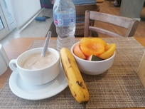 Health breakfast with a bottle of water and cappuccino.