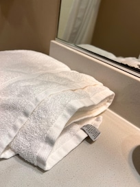 Towels on counter haphazardly, doubt they were clean towels