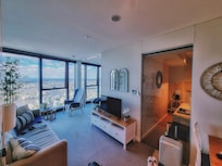 The view of the living room and a sneak-peek into the master king room through the glass.