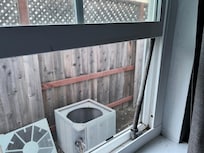 Window propped up with metal rod