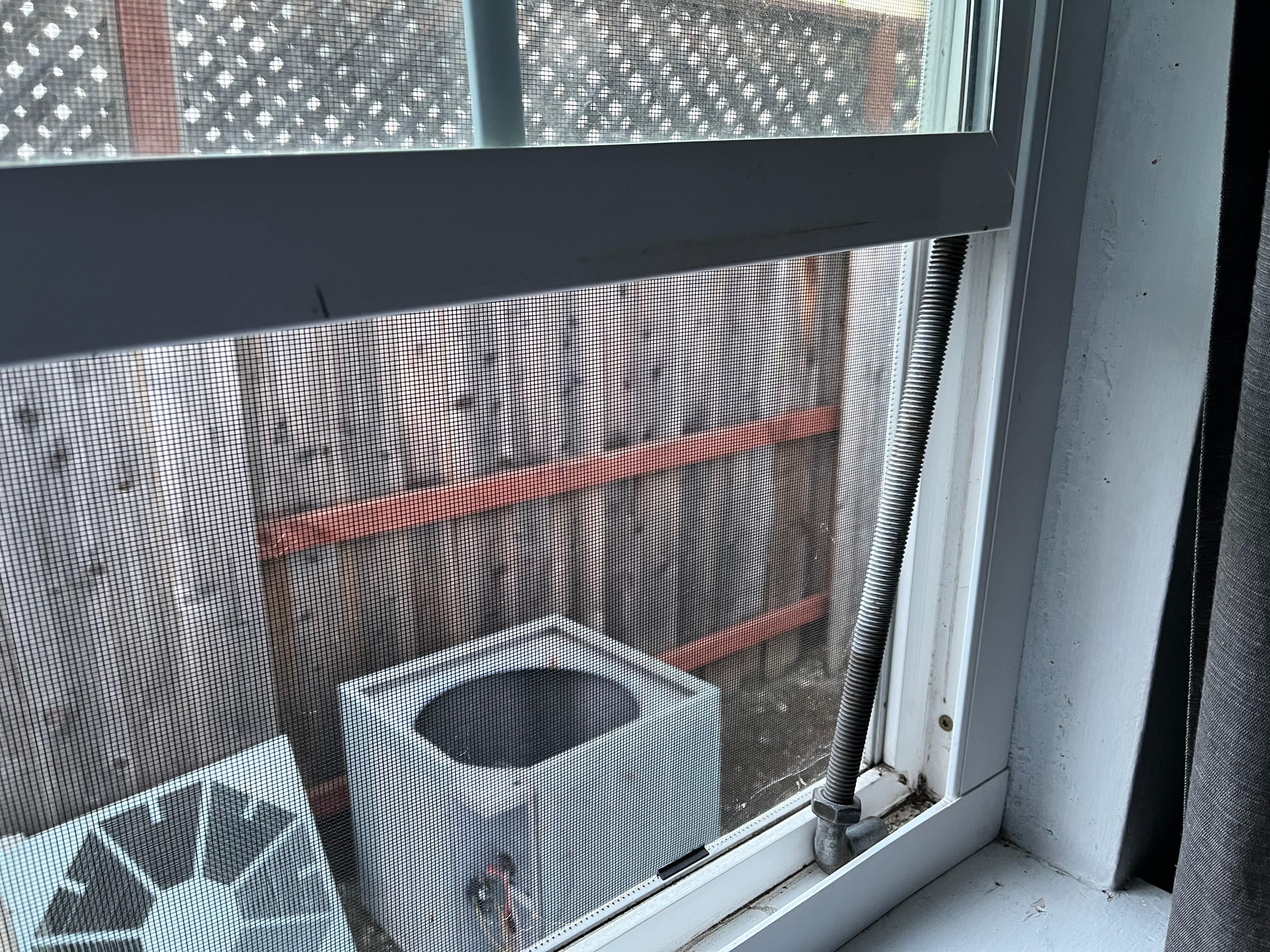 Window propped up with metal rod