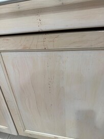 Front of cabinets sticky brown stains