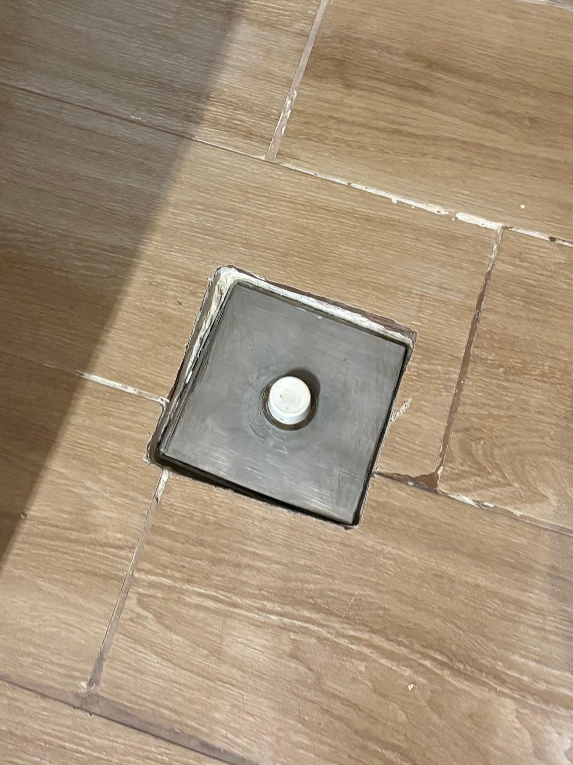 The shower floor with drain covered. 
