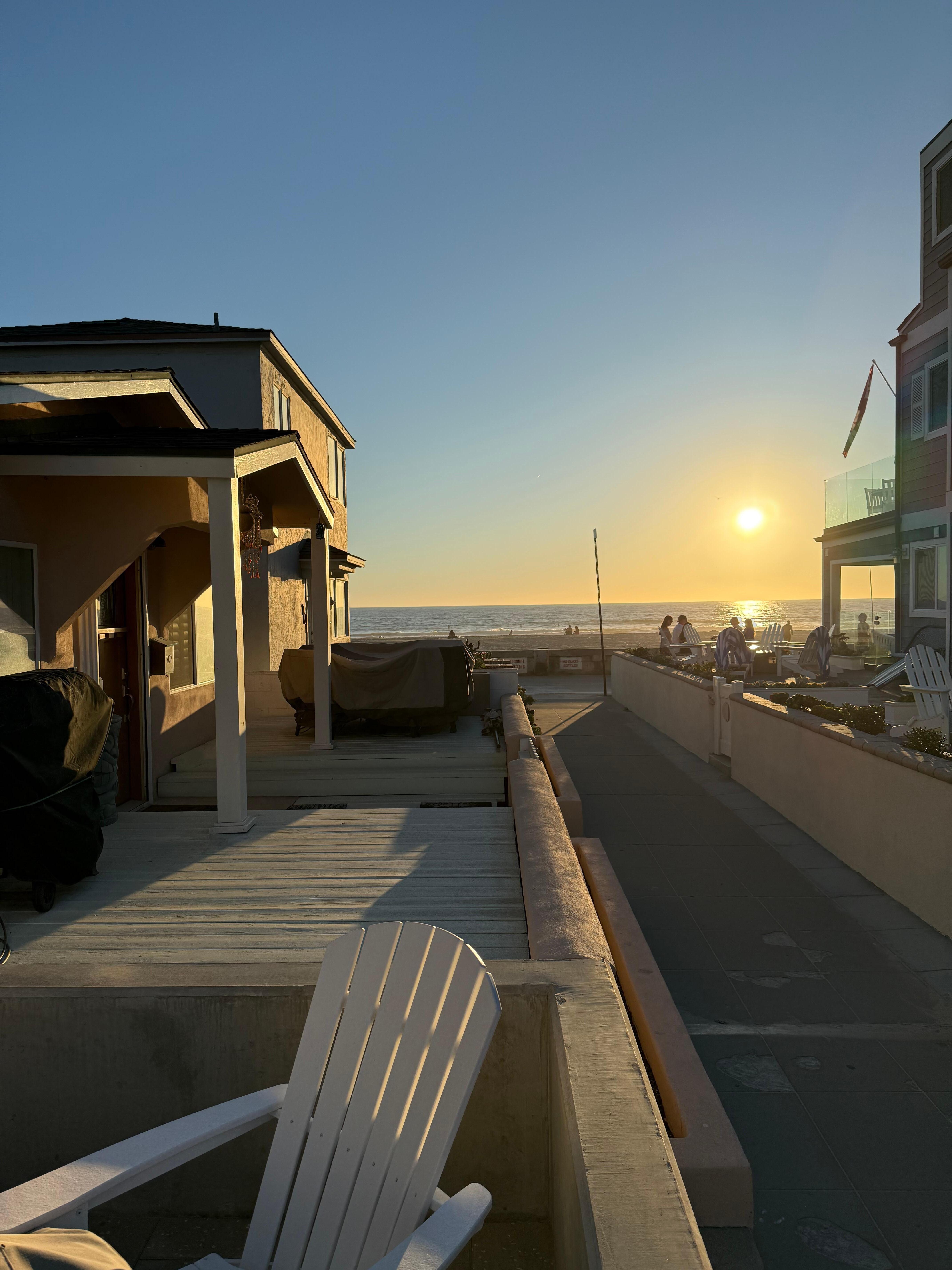 View from front private porch with firepit table & umbrella a nd gas geill