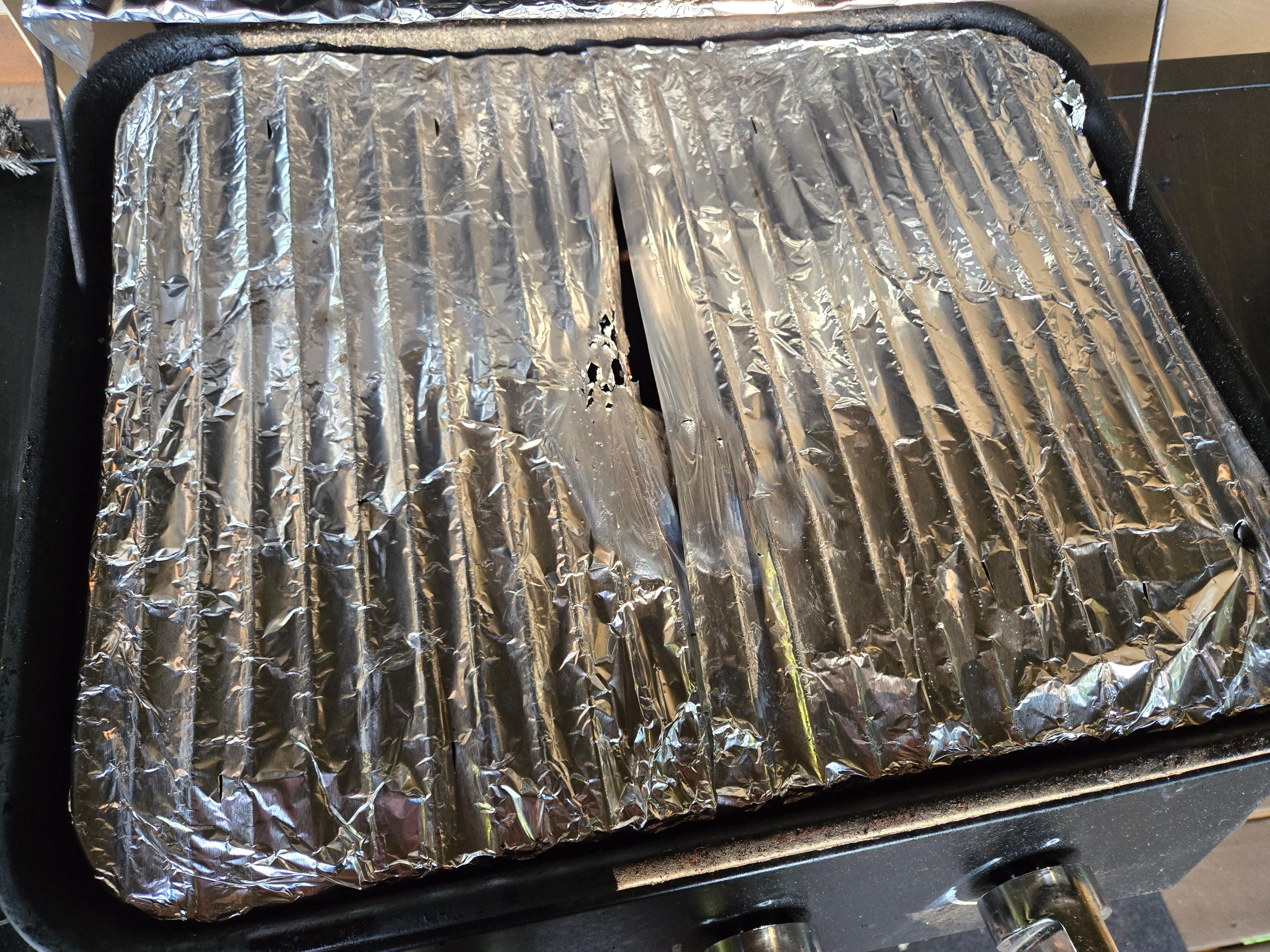 Aluminum foil melted, emiting fumes after 2 minutes of pre-heating at medium heat