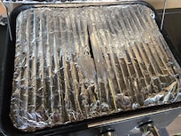 Aluminum foil melted, emiting fumes after 2 minutes of pre-heating at medium heat