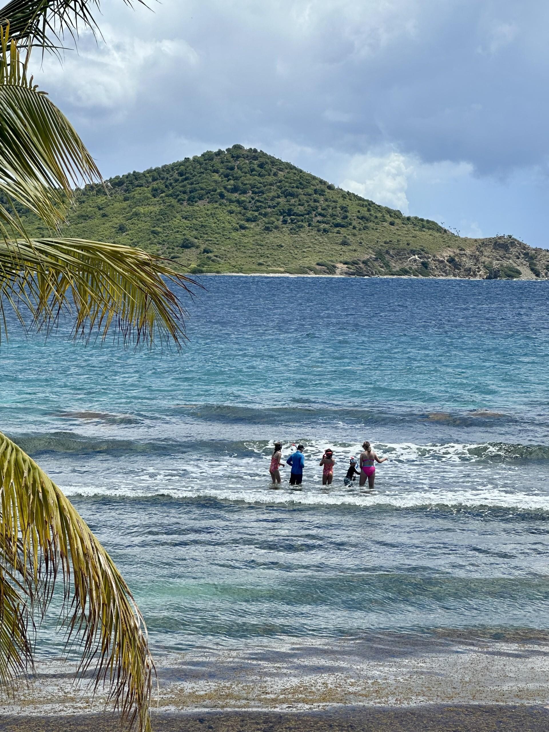 venturing into the ocean off the private beach