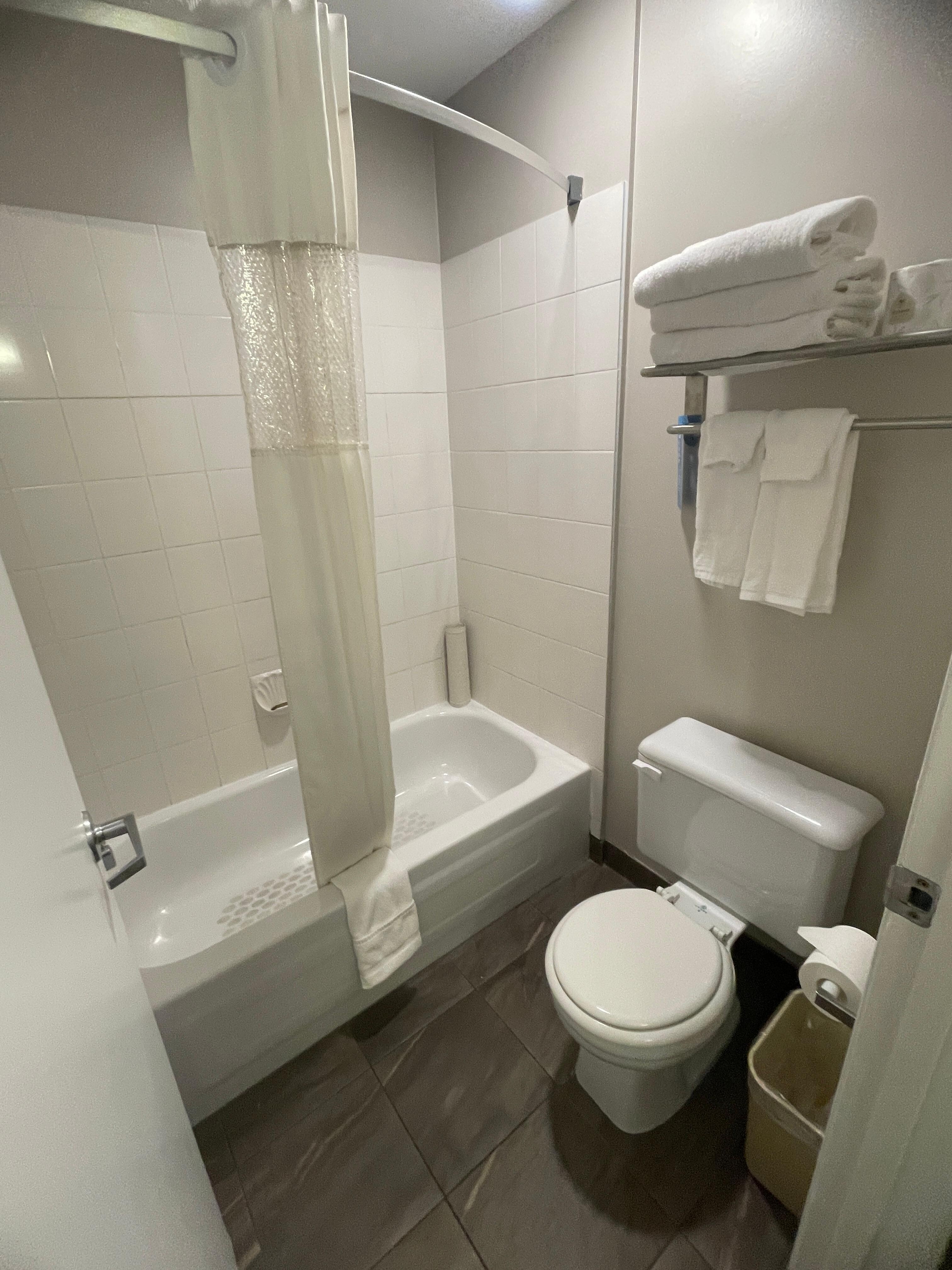 Bathroom with small toilet. Note the sink is outside and part of main room. 