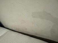 The wall where the bed was. Covered in dirty footprints