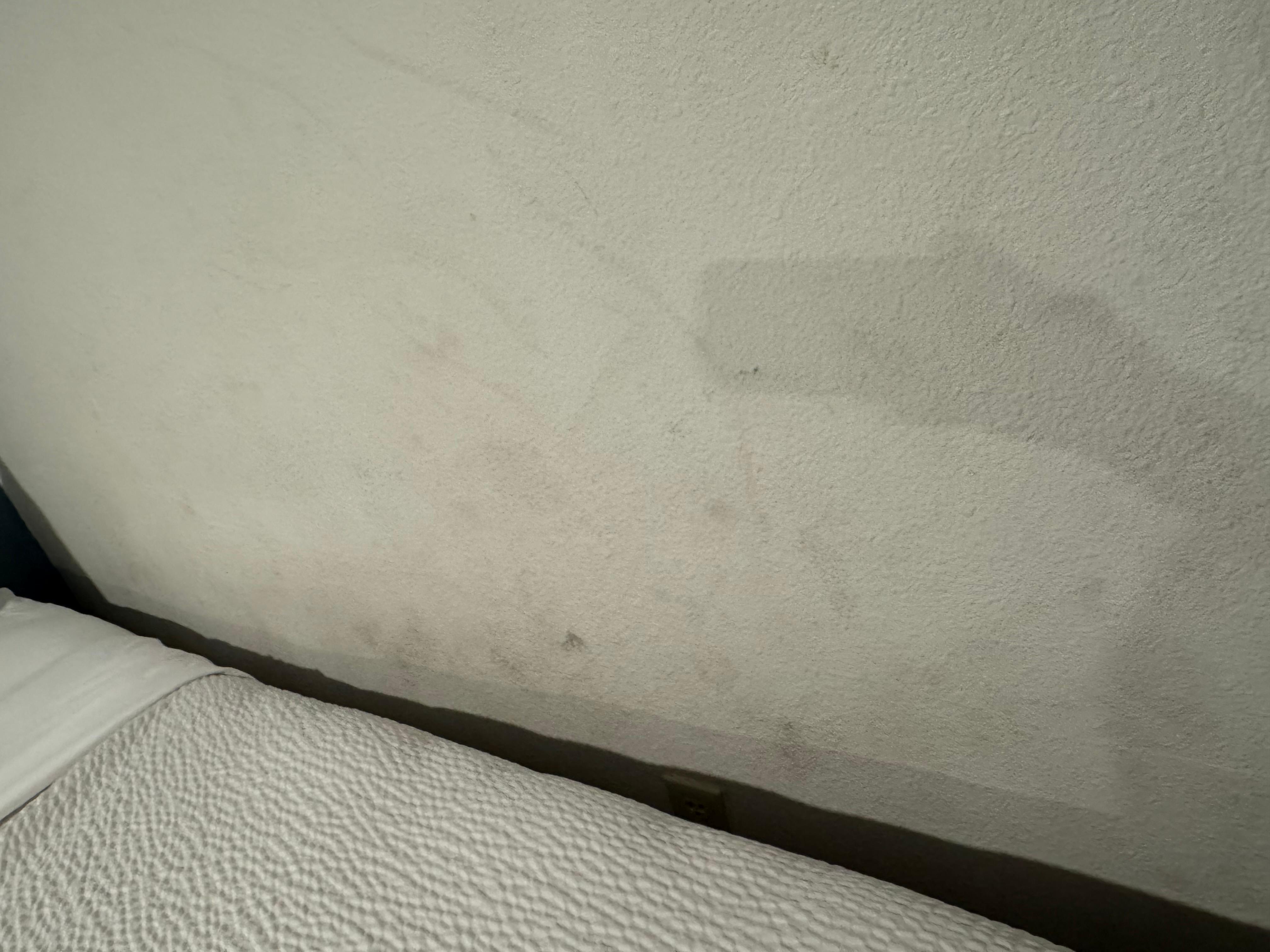 The wall where the bed was. Covered in dirty footprints 