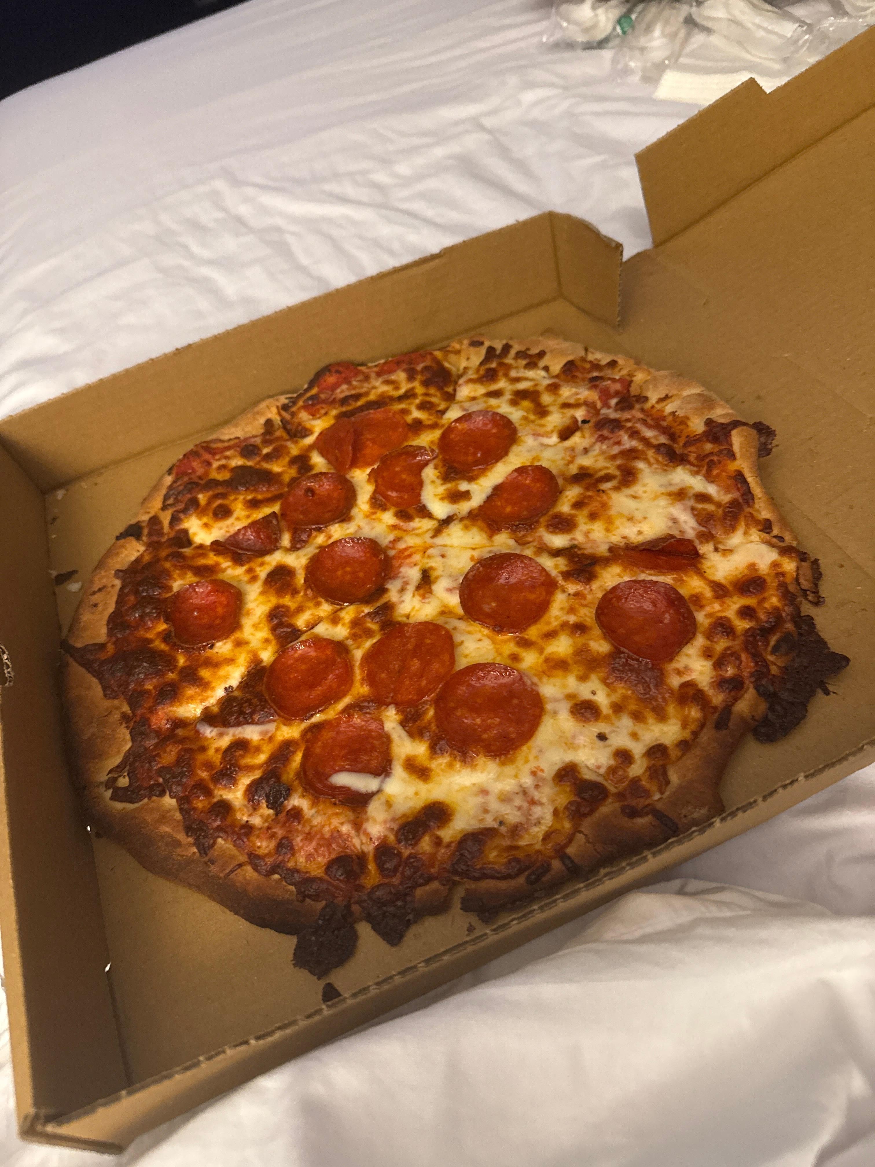 Half the pizza was charred black and thevtaste permeated the entire pizza