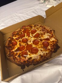 Half the pizza was charred black and thevtaste permeated the entire pizza