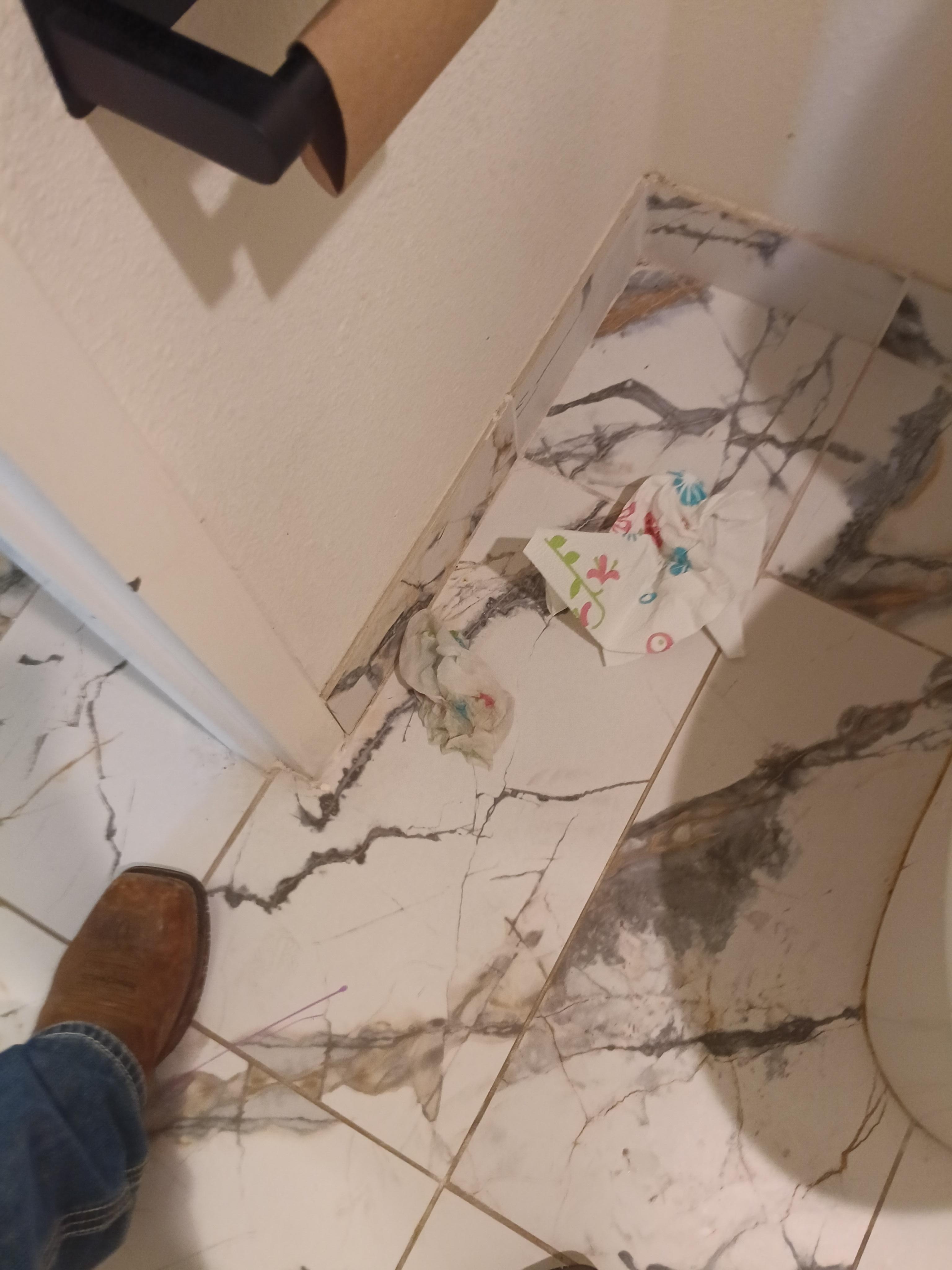 Horrible dirty paper towels on floor 