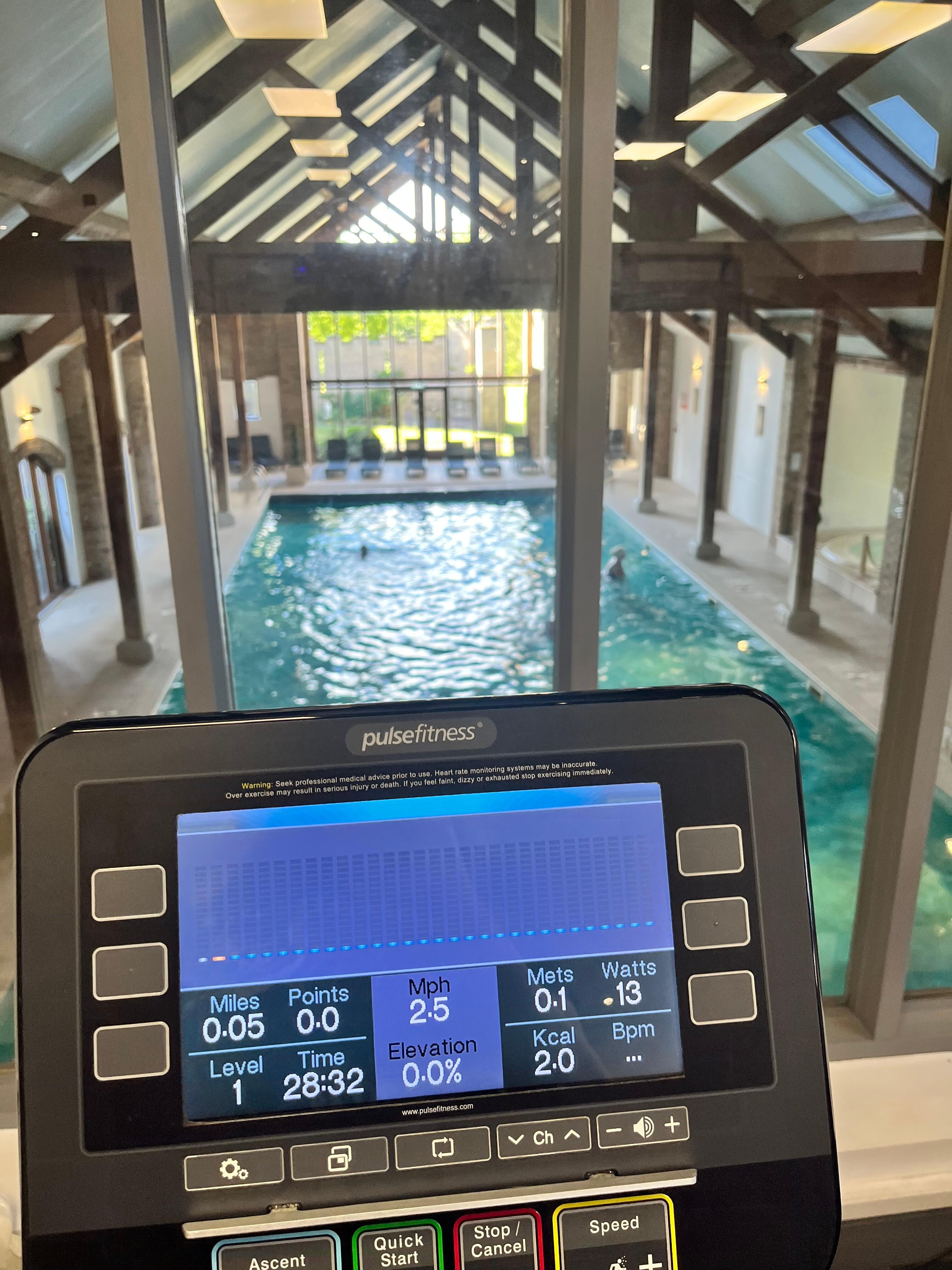 Gym over looking the pool/jacuzzi/sauna:steam room area 