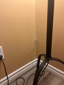 Peeling paint, cracks in the drywall, stained moulding indicating previous flooding/ water damage.