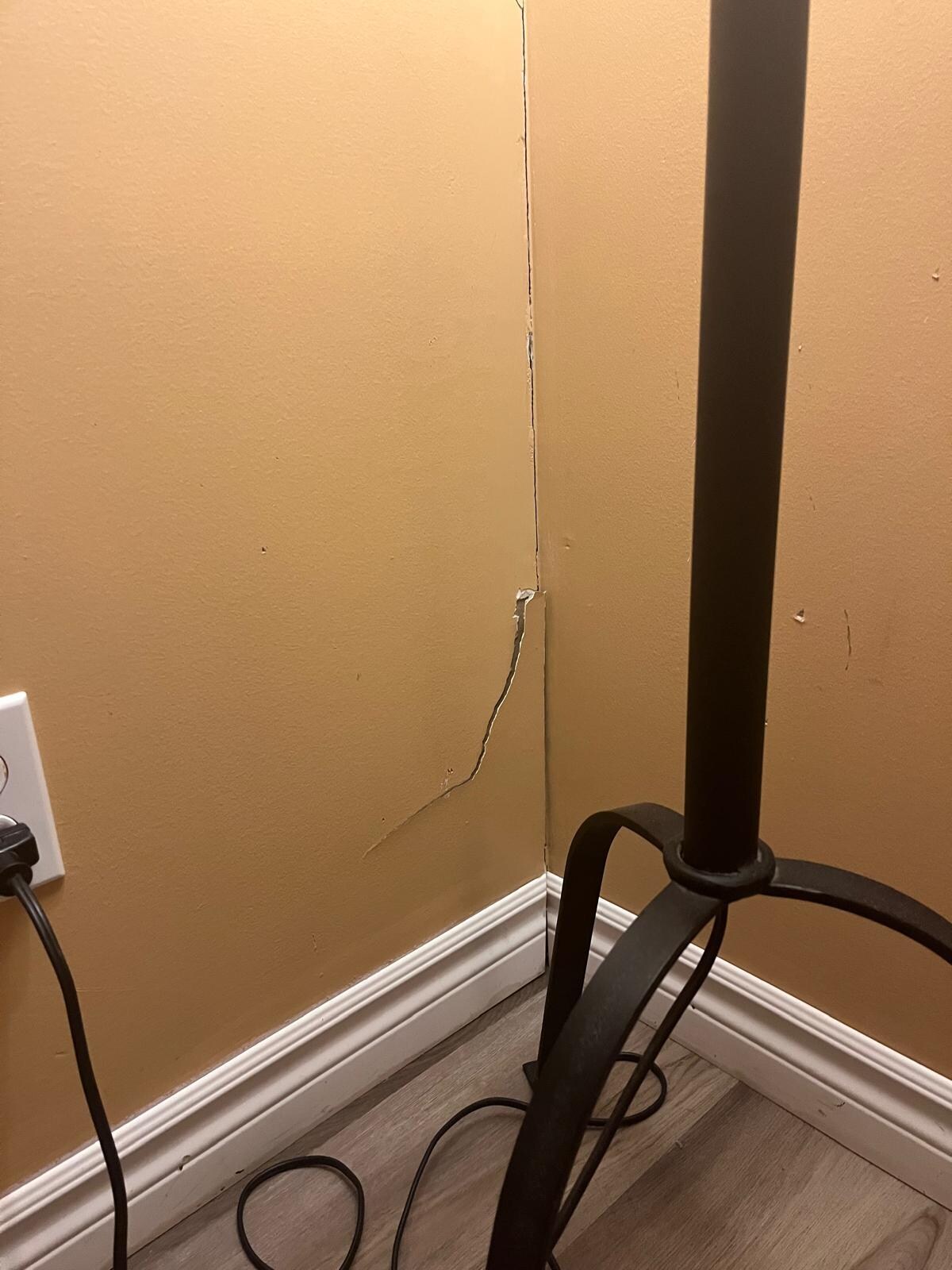 Peeling paint, cracks in the drywall, stained moulding indicating previous flooding/ water damage.