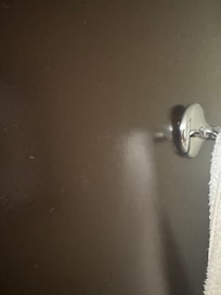 Towel hanger on door was hanging on by a thread