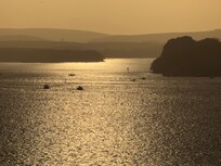 The view across Poole Harbour just before sunset with Brownsea Island & Corfe Castle just visible (taken on a phone)