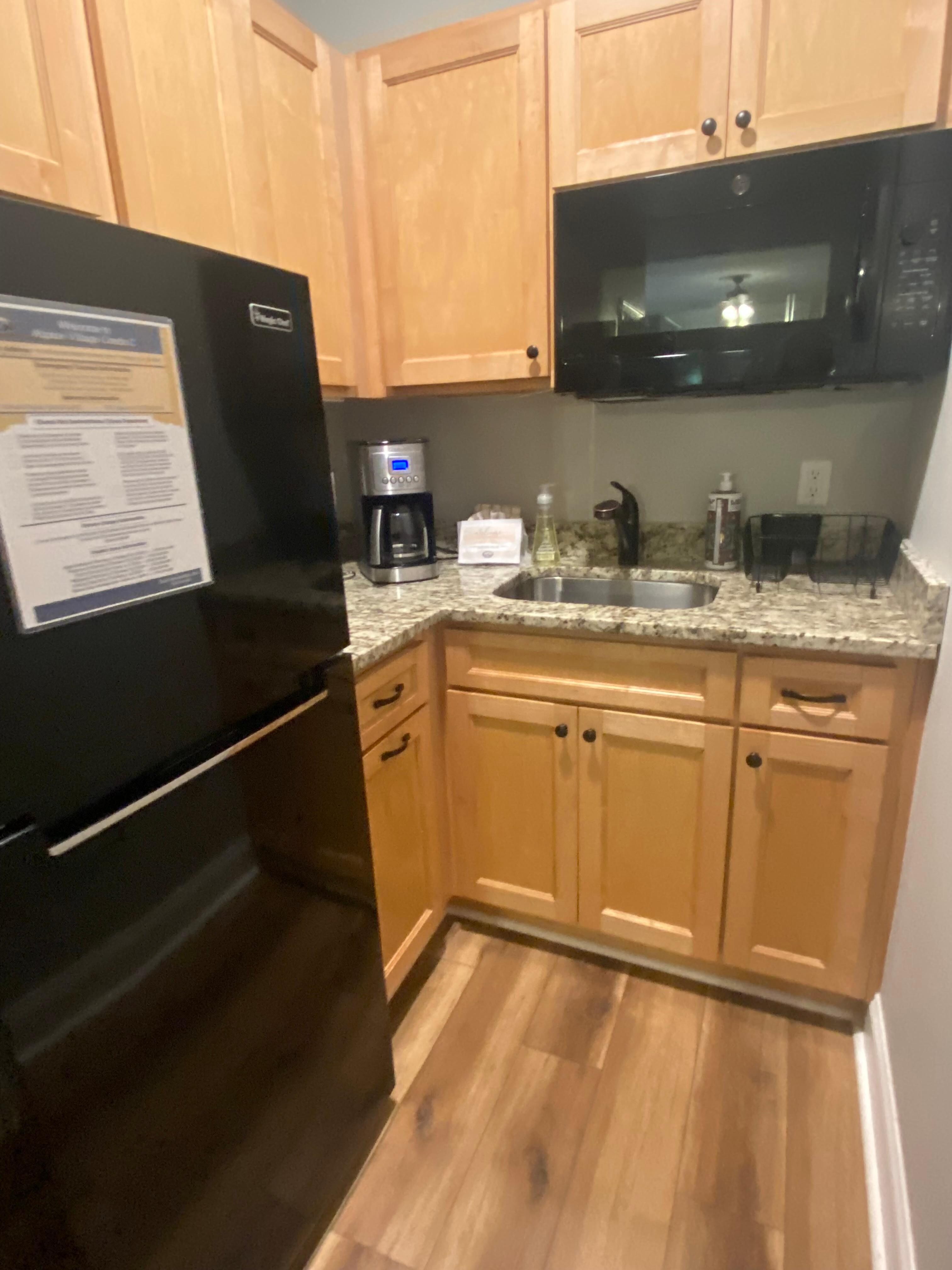 Kitchen is to your right as you enter the room.