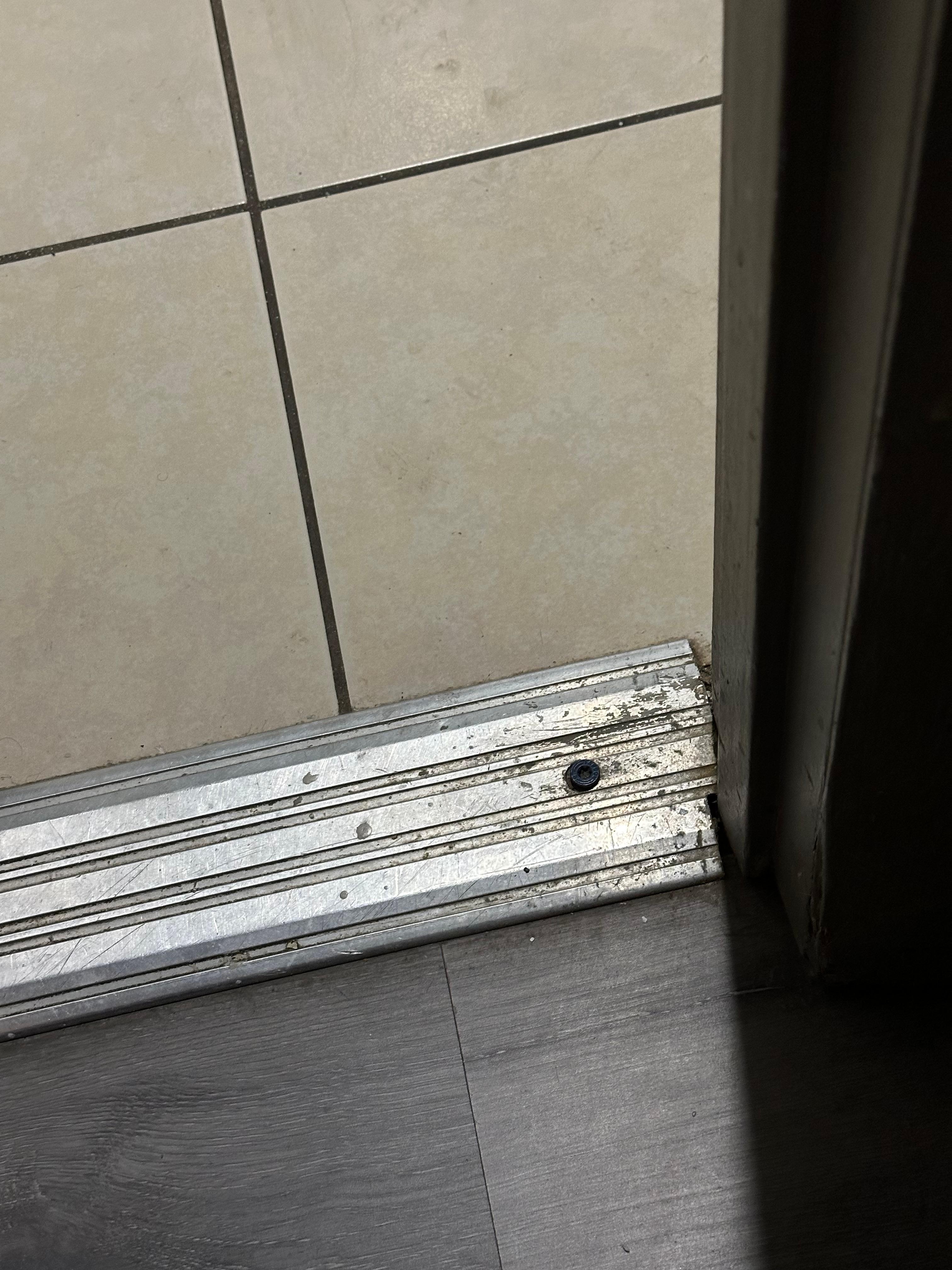 Baseboard between bathroom and wash area watch basin was filthy