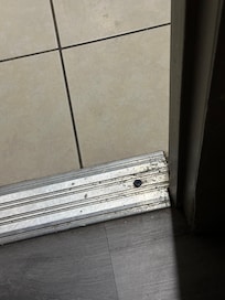 Baseboard between bathroom and wash area watch basin was filthy