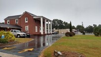 There is an additional wing with more parking space behind the main building.