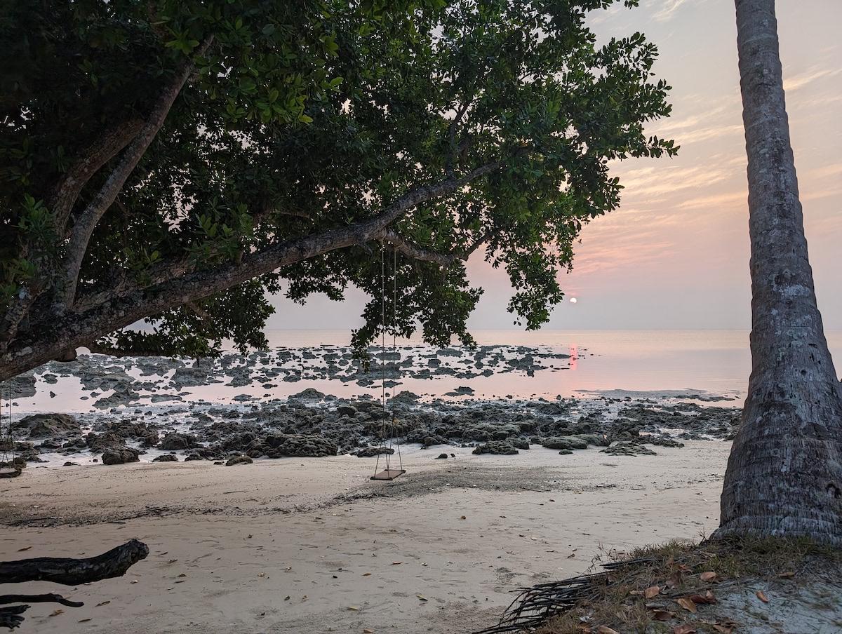 Tilar Siro beach at low tide, perfect for investigating the wildlife in the coral tidepools.