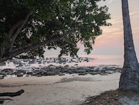 Tilar Siro beach at low tide, perfect for investigating the wildlife in the coral tidepools.