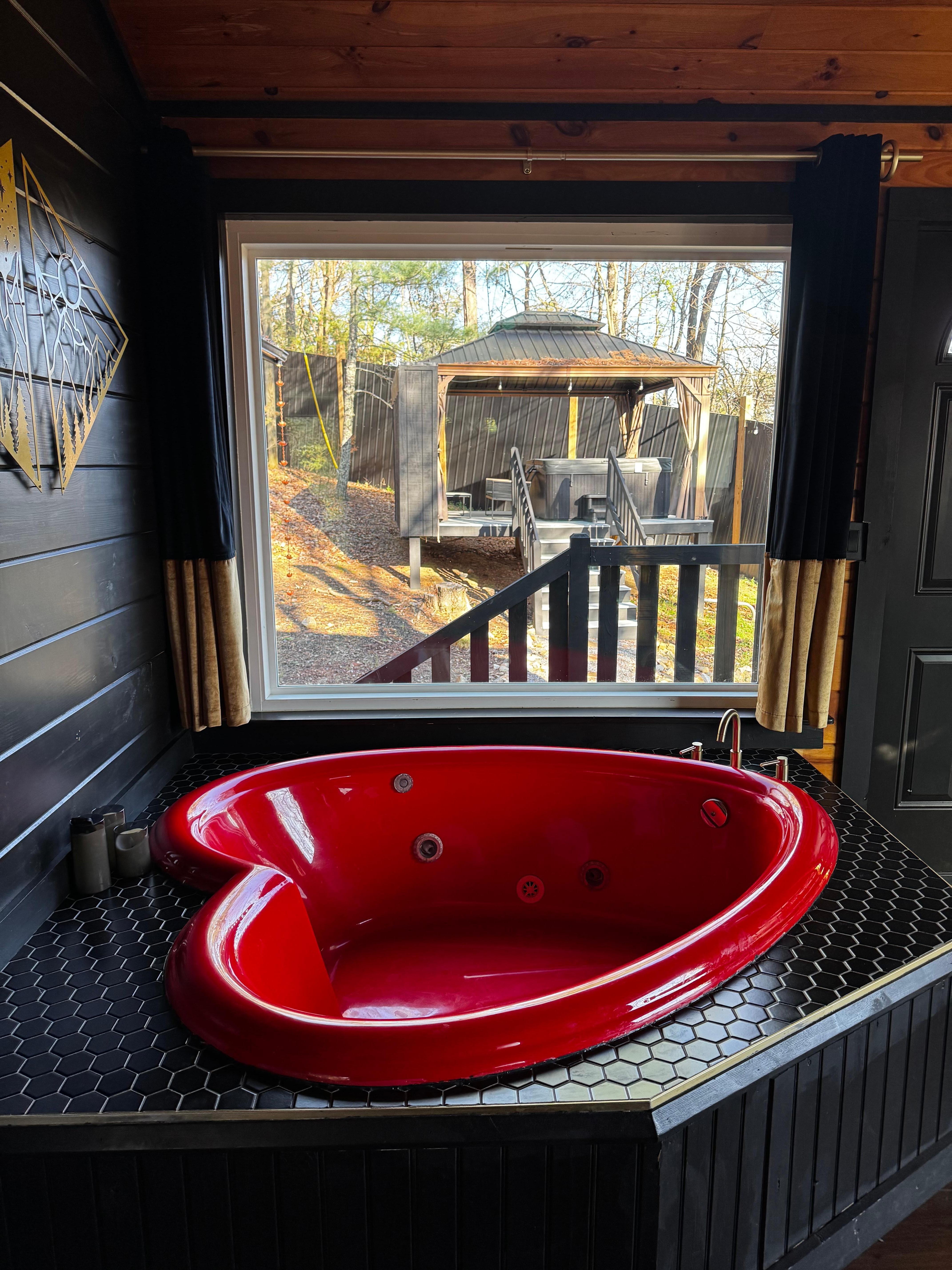 Inside jacuzzi view looking at the outside hot tub deck with TV and fire place