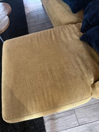 Living room couch covered in dark stains
