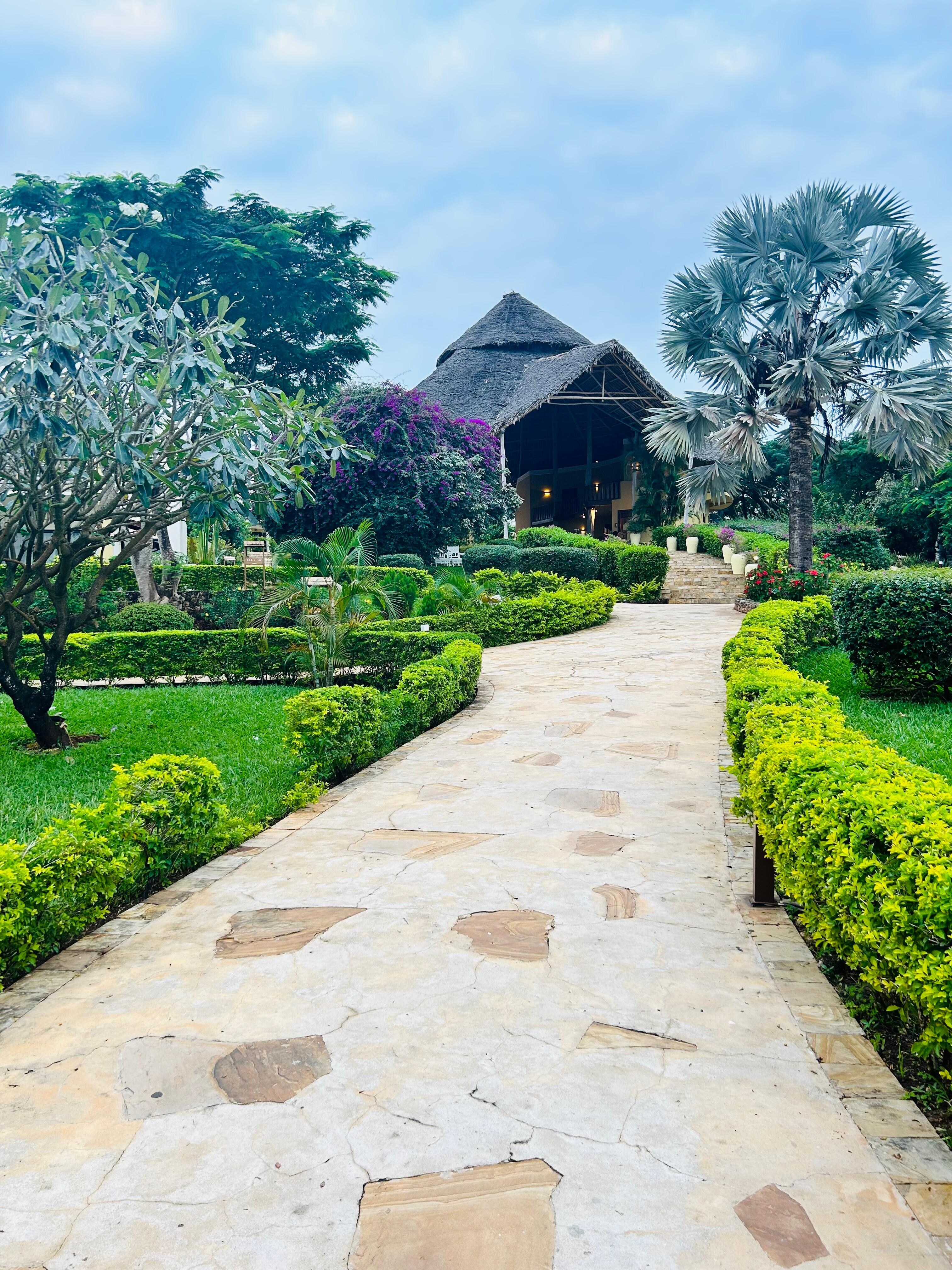 Gardens walking to room - building is the reception