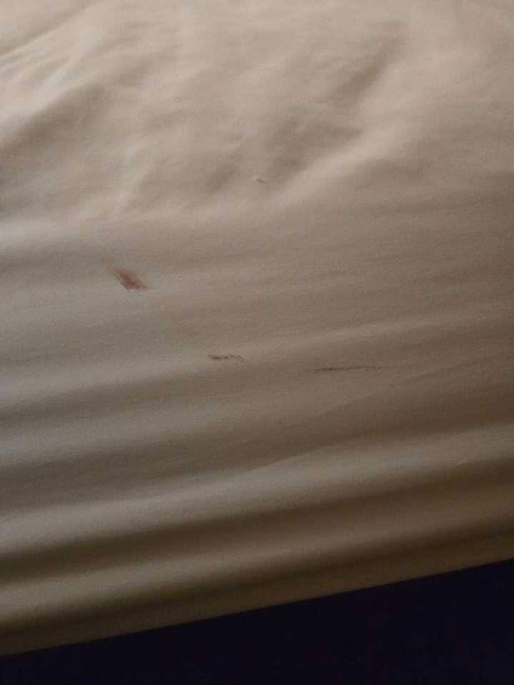 Blood on the sheet on the side of the bed.