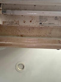 Food splattered on under cabinet lights
