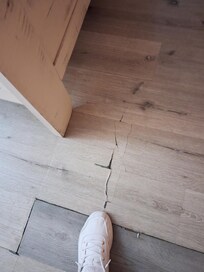 Very fragile flooring in main bedroom leading into bathroom. Not repaired.