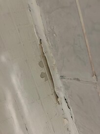 Example of peeling caulk exposing stains