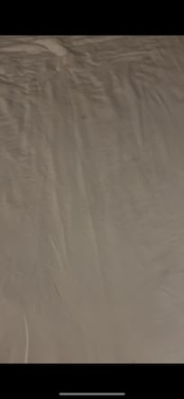 The wrinkles that made it seem like someone rolled out of bed and then made bed without washing