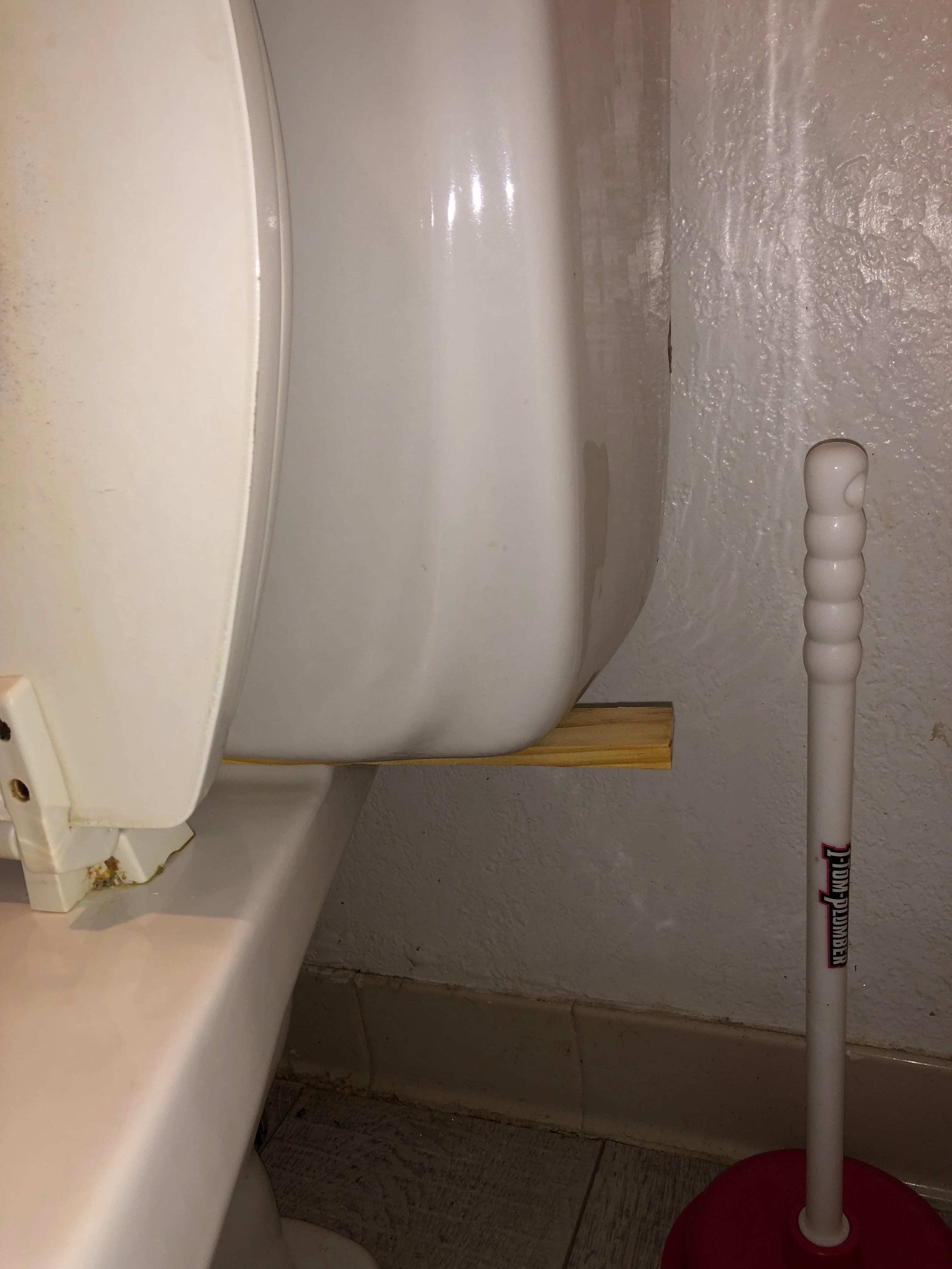 This toilet has a broken wax seal and the tank seal was missing. Hence the wood. 