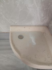 Quarter and soap goo on shower shelf upon arrival.