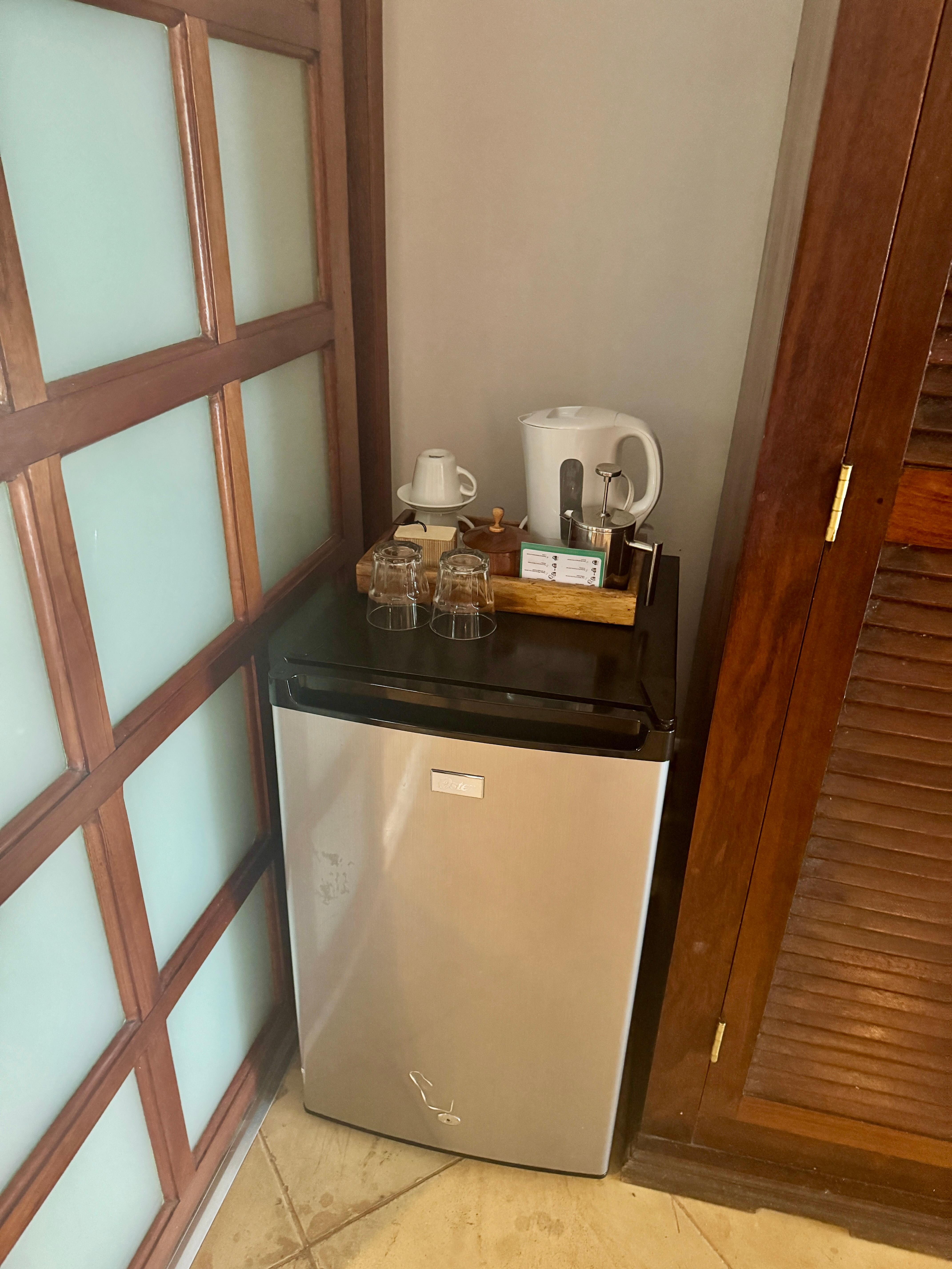 In-room mini fridge with kettle for French press. BYO tea if you’re a tea drinker!
