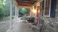 Front Entry with charming rockets and glider to enjoy the view!