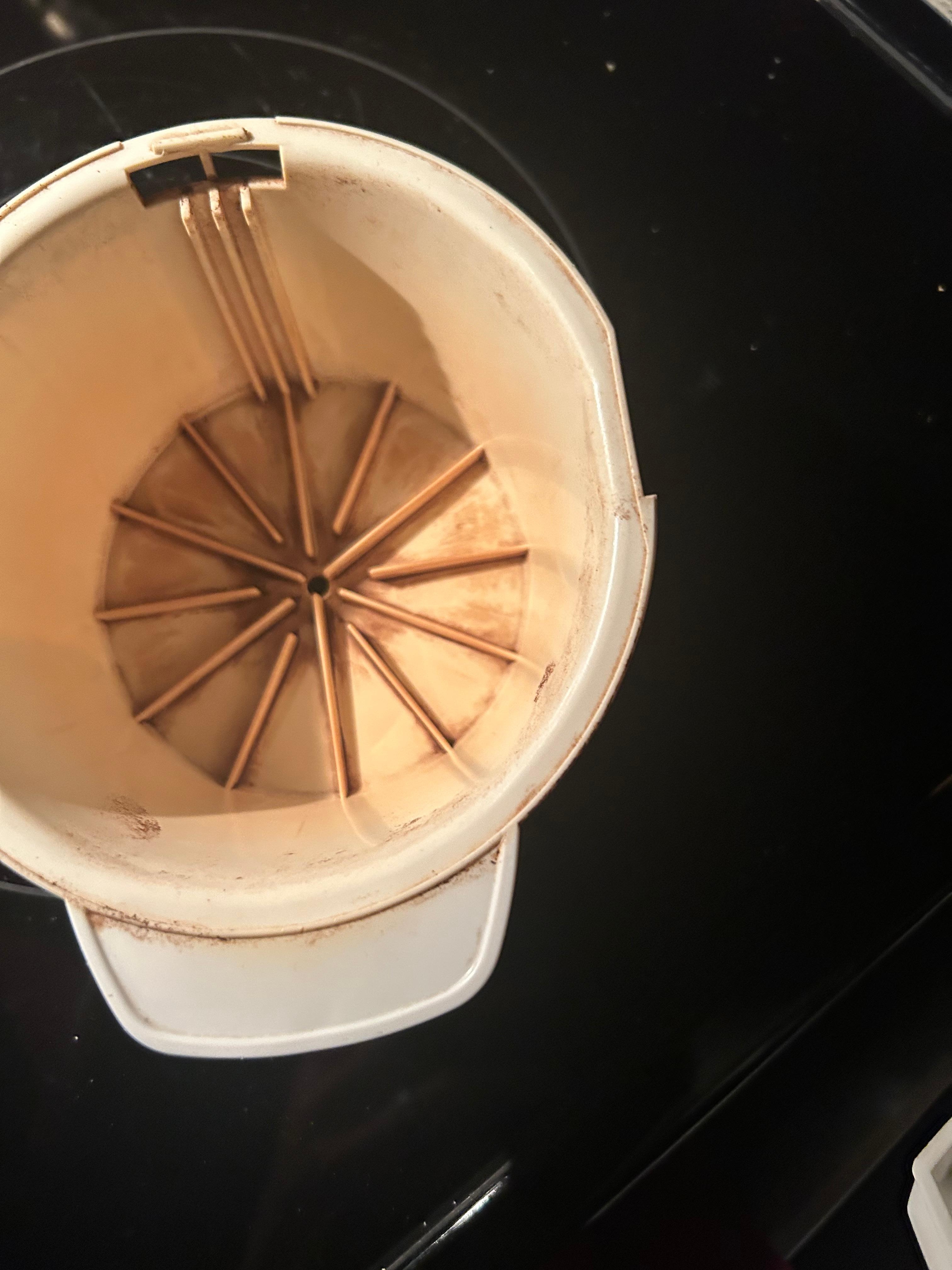 Stained original coffee machine after cleaning