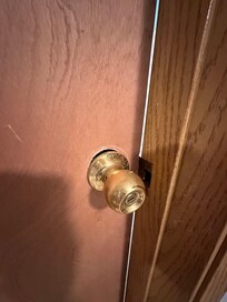The knob of the door is broken.