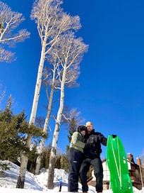Fun sledding on hill of the pond
